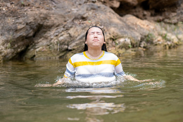 Fat Asian woman coming up from water, Action woman in river 