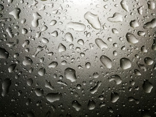 Raindrops on a car, concept about fresh and rainy season