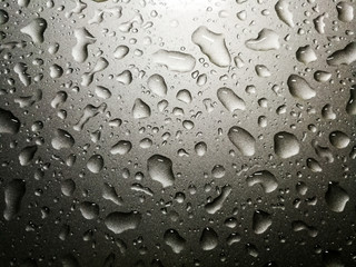 Raindrops on a car, concept about fresh and rainy season