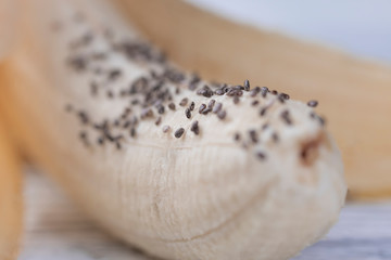 Ripe banana with chia seeds on a wooden background