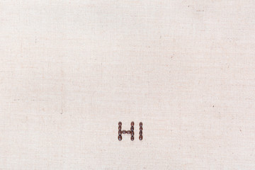 The word Hi written with coffee beans shot from above, aligned at the bottom.