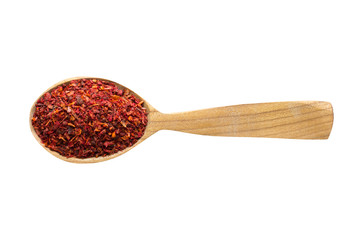 dried tomato powder in wooden spoon isolated on white background. spice for cooking food, top view.