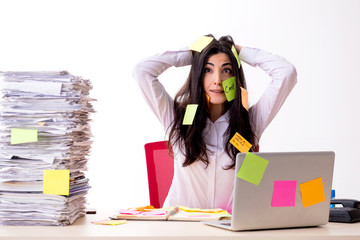 Young female employee in conflicting priorities concept 