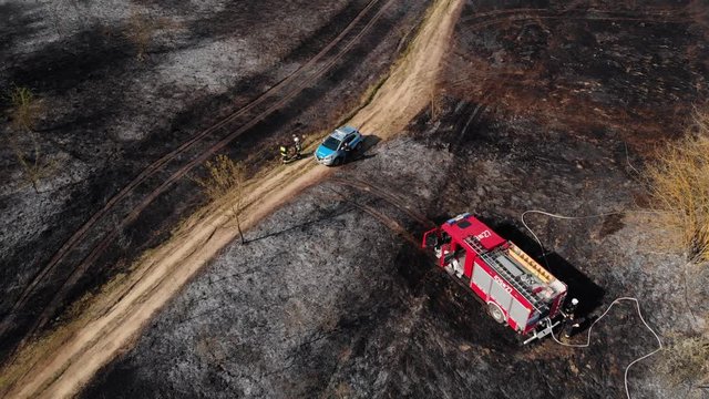 Emergency services at a forest fire incident spot in Garwolin woods, drone shot