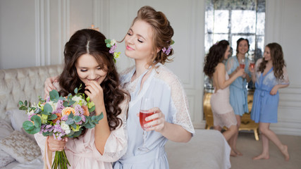 Young beautiful brunette at a bachelorette party. A young woman with a bouquet of flowers,