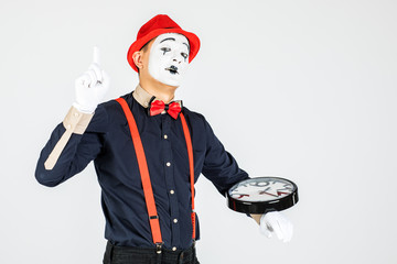 Funny clown with clock isolated on white background.