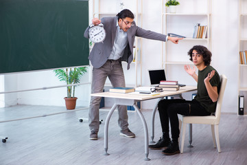 Young teacher and student in the classroom 