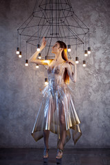 robotic woman in a plastic dress, future fashion concept. Stylish young woman