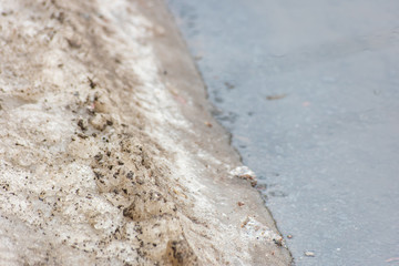 Wet asphalt with dirty snow