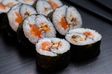 Japanese sushi and rolls on a black background
