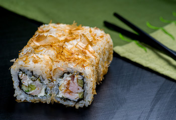 Japanese sushi and rolls on a black background
