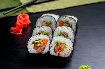 Japanese sushi and rolls on a black background