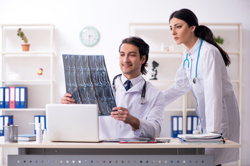 Two young doctors working in the clinic 