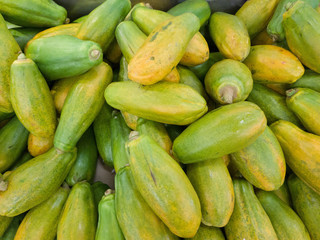 Green papayas on the market