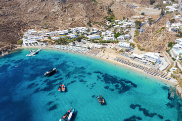 Aerial view to the famous celebrity beach Psarou on the Greek island of Mykonos, Cyclades - obrazy, fototapety, plakaty