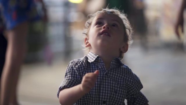 A kid jumping and dancing during night time along with a blurry background - bokeh , beautiful child / toddler.