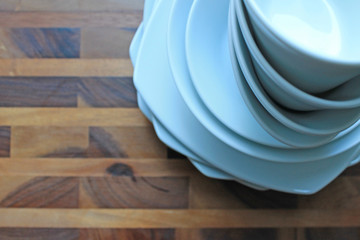 Clean white dishes on brown wooden Board
