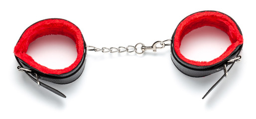 Bondage, BDSM black leather handcuffs with red fur inside, on  chain. Sex toys. Isolated on white...