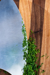 Fresh Chopped Dill with Mezzaluna Chopping Blade and Striped Wooden Cutting Board