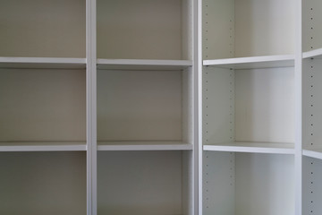 Empty white bookshelves