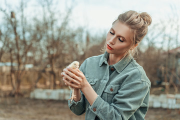 beautiful woman with a chicken in her hands