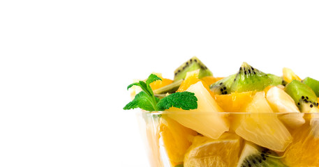 Bowl of healthy fresh fruit salad on white background