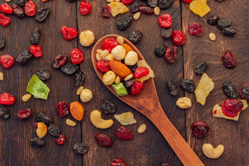 nuts and dried fruits assortment on oak table top view