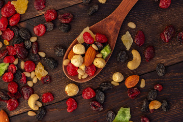 nuts and dried fruits assortment on oak table top view