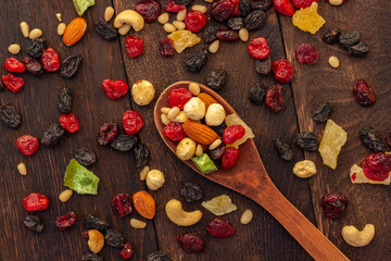 nuts and dried fruits assortment on oak table top view
