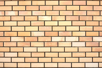 Horizontal photo of an red wall. The surface of the wall has a decorative relief.