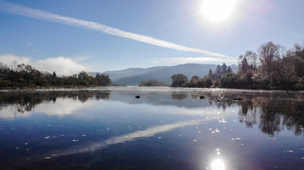 Beautiful autumn nature in Carpathians, Ukraine. Mountain river Stryi, sunny weather and blue sky