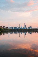 Sunset View of Manhattan skyline from Jacqueline Kennedy Onassis Reservoir in Central Park, reflection in water