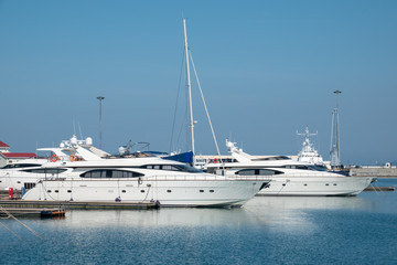 Fototapeta premium Beautiful clear day in the sea harbor with moored yachts.