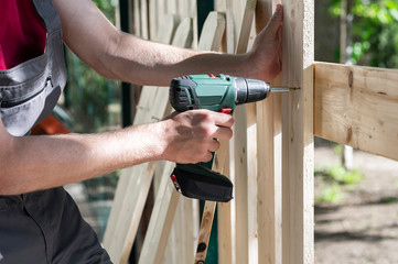 Young man holding drill-drive