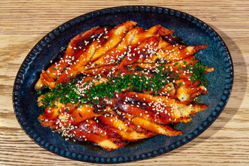 Closeup japanese donburi dish - Unagi. Bowl filled with steamed white rice, topped with fillets of eel (unagi), glazed with a sweetened soy based sauce, called Tare