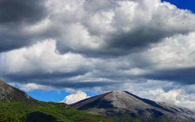 Colorful mountain landscape with blue sky and gray clouds