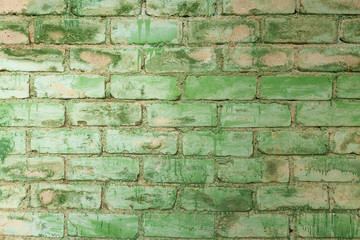 Brick wall painted green with brush