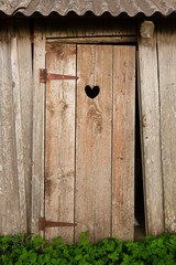 Outdoor toilet with heart shaped hole in it