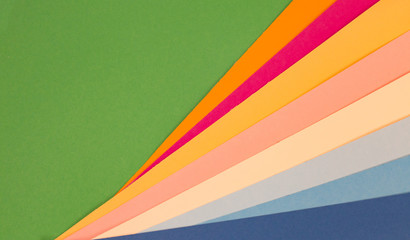 sheets of colored paper. Many colored sheets of paper are laid out in the harsh composition. background of colored paper.