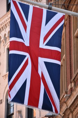 Fototapeta na wymiar waving UK flag in the blue sky, Union Jack flag 