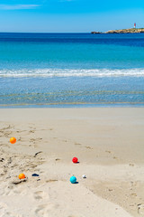 Crystal clear blue Mediterranean sea water on St.Croix Martigues beach and kids beach toys, Provence, France