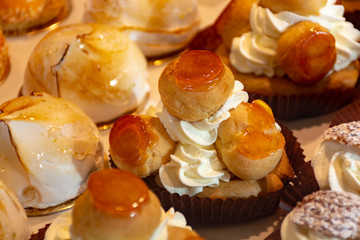Freshly baked stuffed sweet pastries Orange Lactee and Dome Citron with fruits in traditinal French bakery in small village in Provence