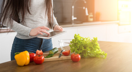 Young trendy woman cooking healthy food in the morning