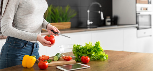 Young trendy woman cooking healthy food in the morning