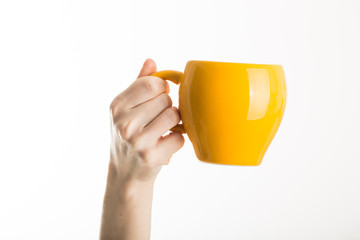 Hand holding tea, coffee cup isolated