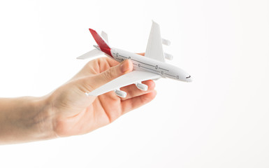 Hand with airplane on isolated background