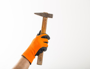 Old hammer in man hand isolated