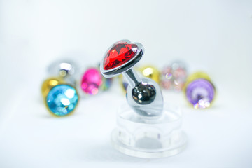 many anal plugs set. sex toys with crystals isolated on white background.