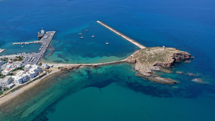 Aerial drone panoramic view of iconic and unique Temple of Apollon or Portara (Gate) with breathtaking views to port - town and castle of Naxos island and the Aegean blue sea, Cyclades, Greece