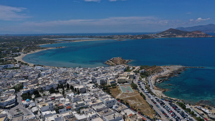 Fototapeta premium Aerial drone photo of iconic port of Naxos island featuring uphill castle and beautiful Temple of Apollon or Gate, Cyclades, Greece